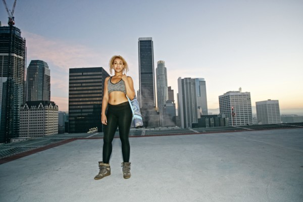 Mixed race woman standing on urban rooftop