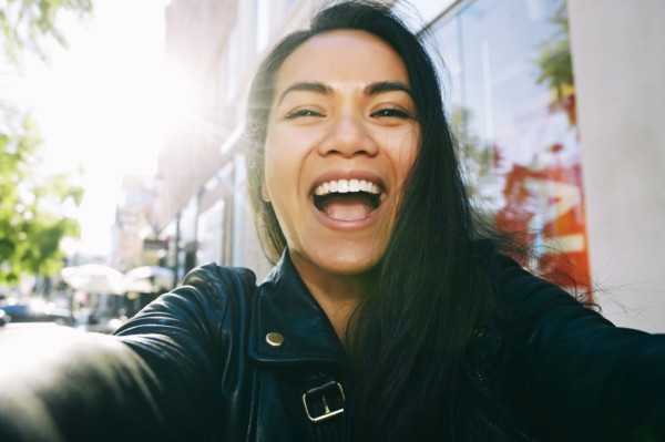 Asian woman smiling outdoors