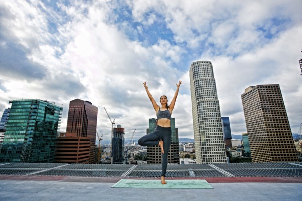 Caucasian woman doing yoga urban rooftop