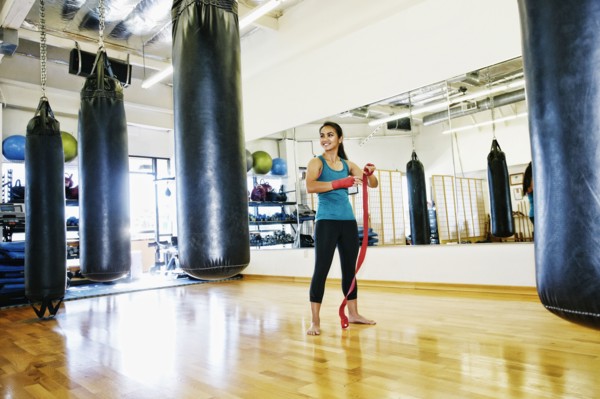 Asian woman wrapping hand in gymnasium