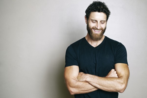 Smiling Caucasian man with beard looking down