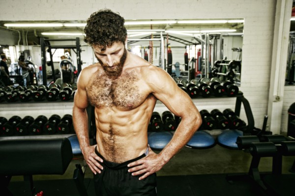Mixed Race man resting in gymnasium