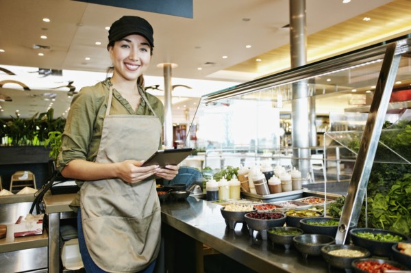Mixed Race food court worker using digital tablet