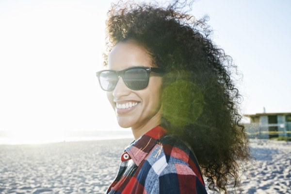 Portrait of smiling Hispanic woman at beach