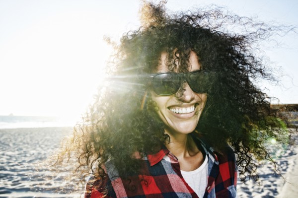 Portrait of smiling Hispanic woman at beach