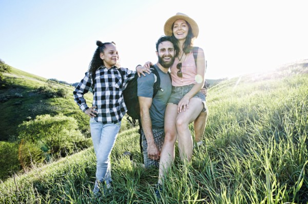 Portrait of smiling family posing on hill