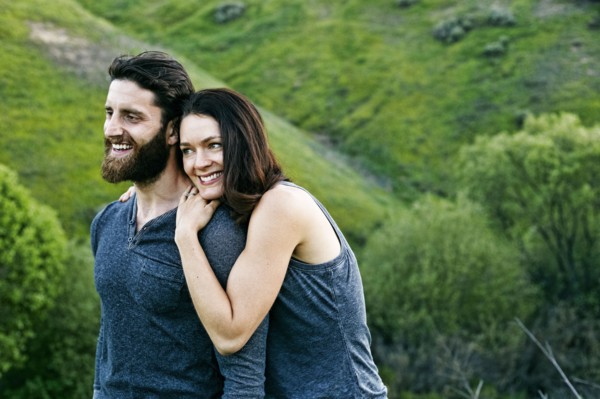 Smiling couple standing on hill