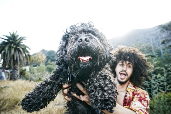 Mixed Race man holding shaggy dog