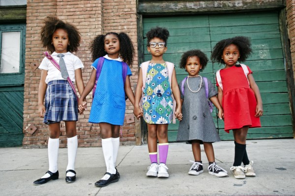 Serious girls posing on city sidewalk