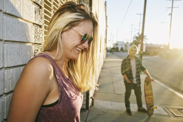 Caucasian woman laughing on sidewalk