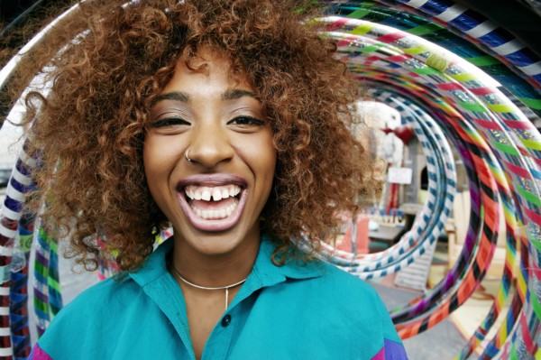 Portrait of black woman laughing near hoops