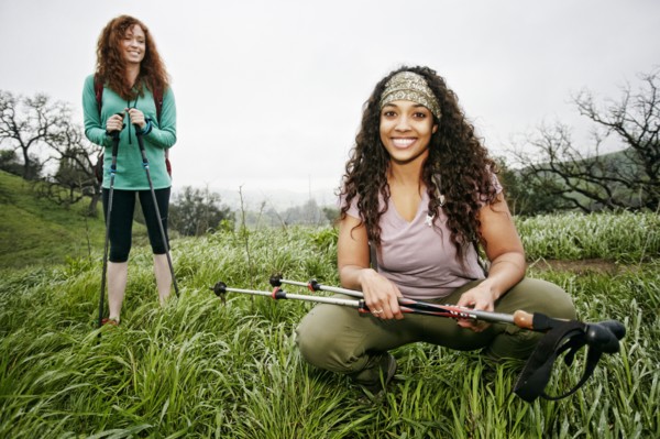 Portrait of smiling women hiking with walking sticks