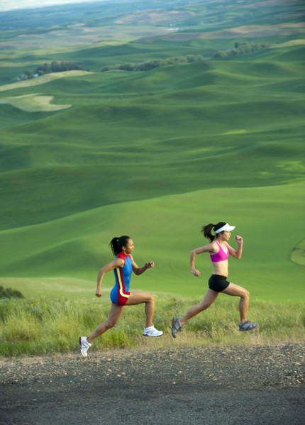 Women runners running in countryside