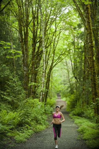 Caucasian woman running on remote path