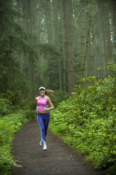 Caucasian woman running on remote path