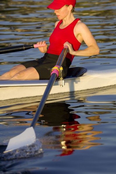 Person rowing sculling boat on river