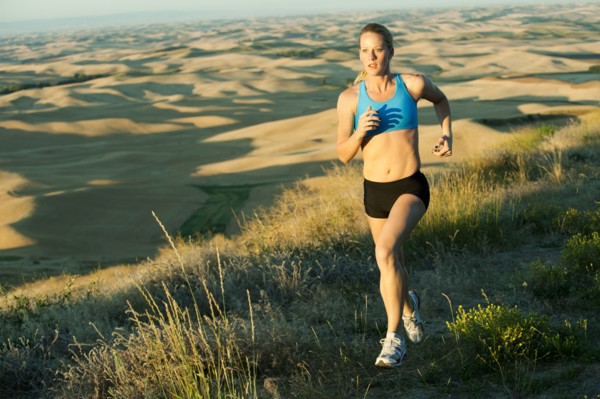 Caucasian woman running in remote area