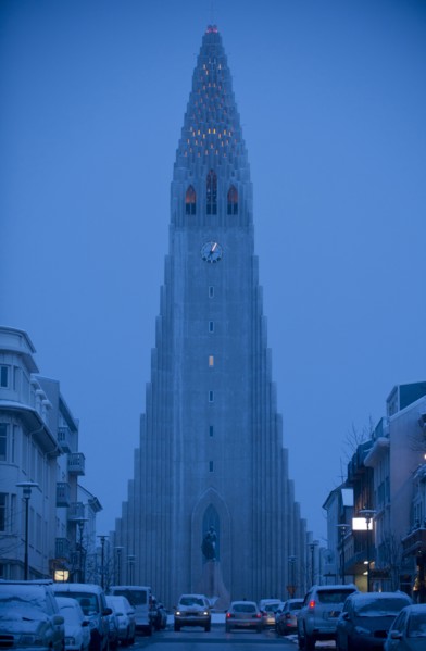 Monument overlooking Reykjavik city street at dusk
