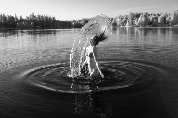 Korean woman flipping hair in lake