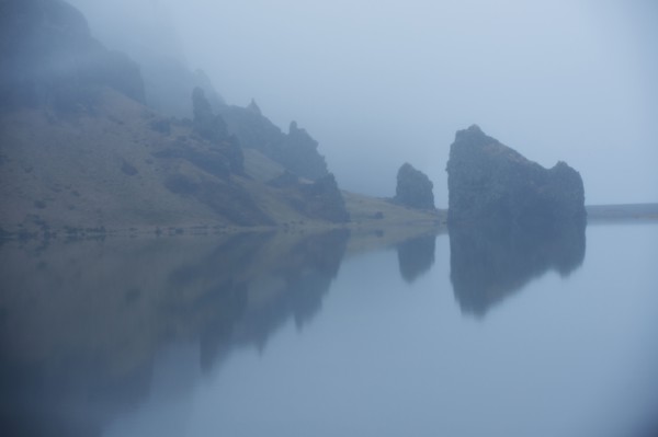 Rock formations and remote misty lake