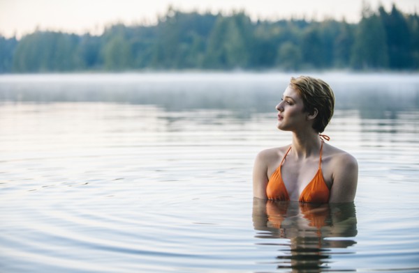 Caucasian woman swimming in still lake