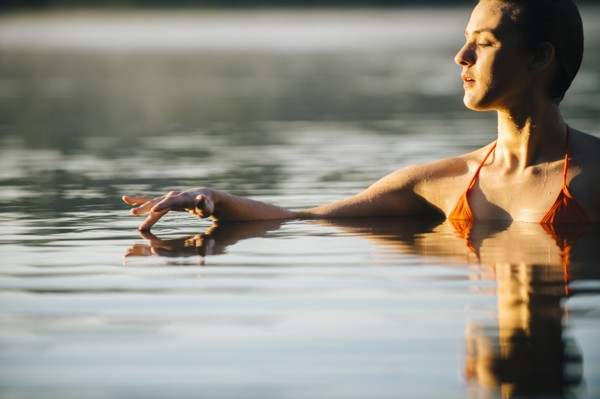 Caucasian woman swimming in still lake