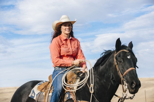 Caucasian woman smiling on horse