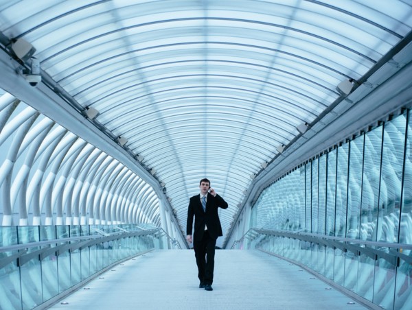 Caucasian businessman talking on cell phone in tunnel