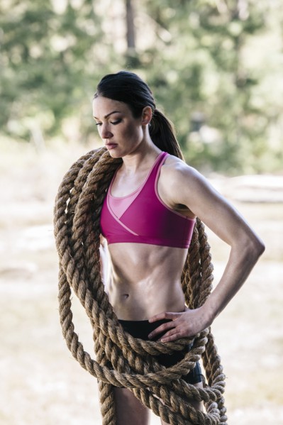Caucasian woman carrying heavy ropes
