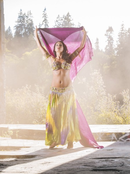 Belly dancer holding purple fabric