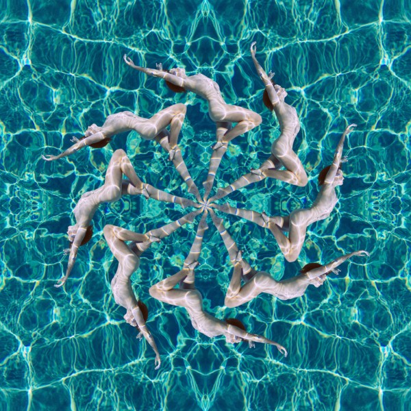 Multiple exposure of Caucasian woman swimming in spiral