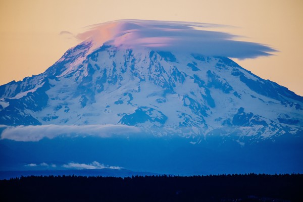 Clouds over snowy mountain