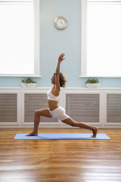 Mixed race woman practicing yoga