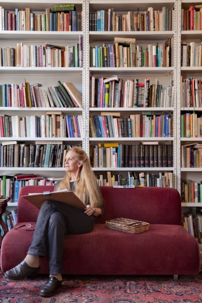 Caucasian woman sitting on sofa sketching