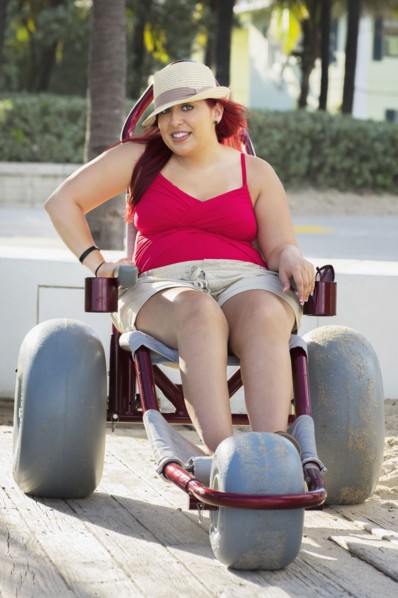 Paraplegic woman in wheelchair on walkway