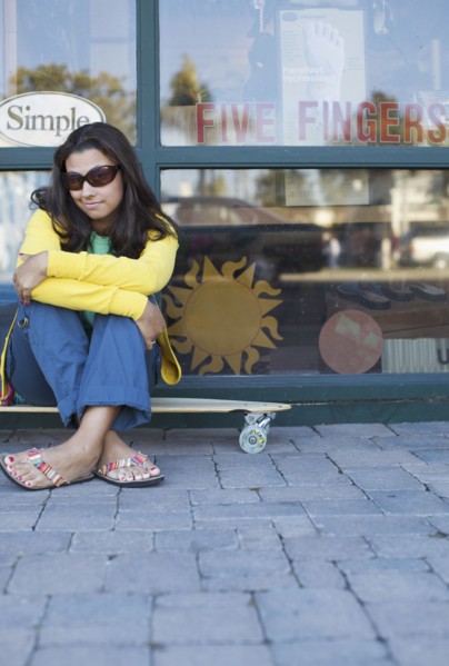 Mixed race woman sitting on skateboard