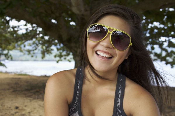 Smiling mixed race teenager in sunglasses