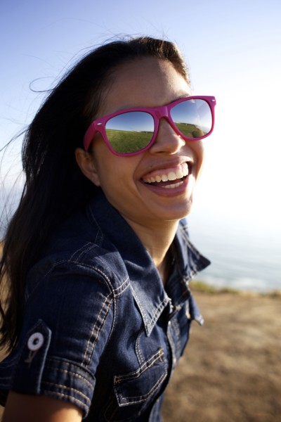 Smiling mixed race woman laughing on beach