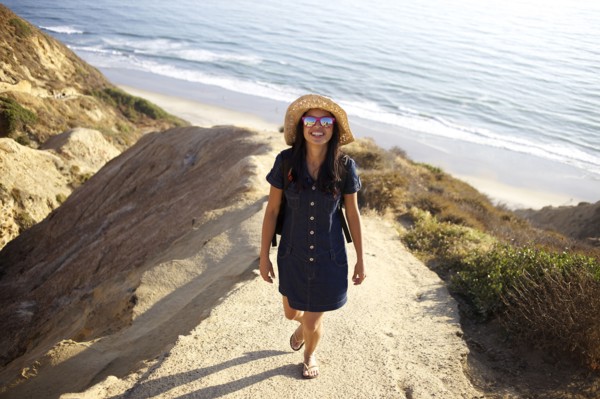 Mixed race woman standing on rock at beach