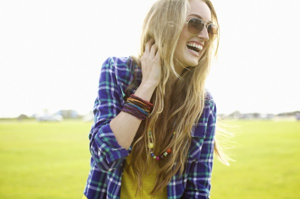 Laughing Caucasian woman standing in field