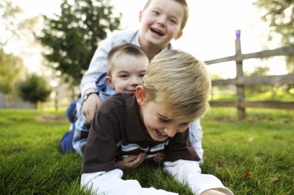 Caucasian brothers playing in grass