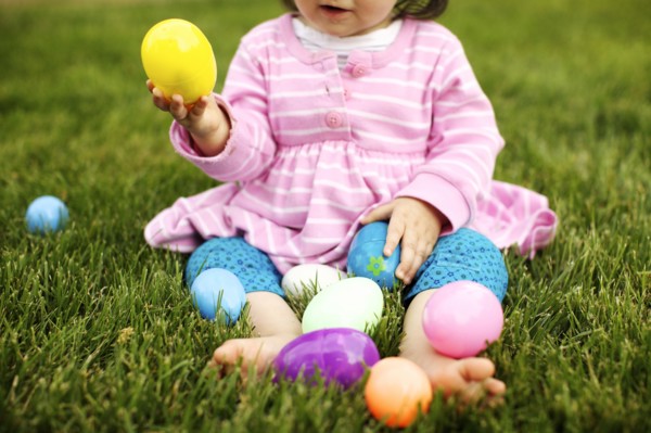 Mixed race girl playing with Easter eggs