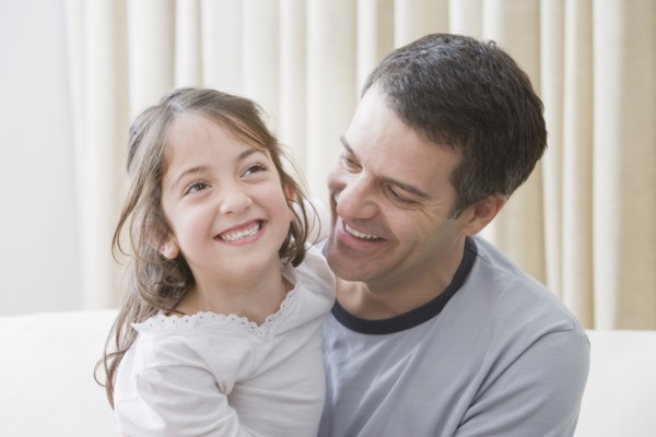 Hispanic father and daughter smiling