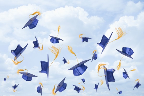 Graduation mortarboards being thrown in the air