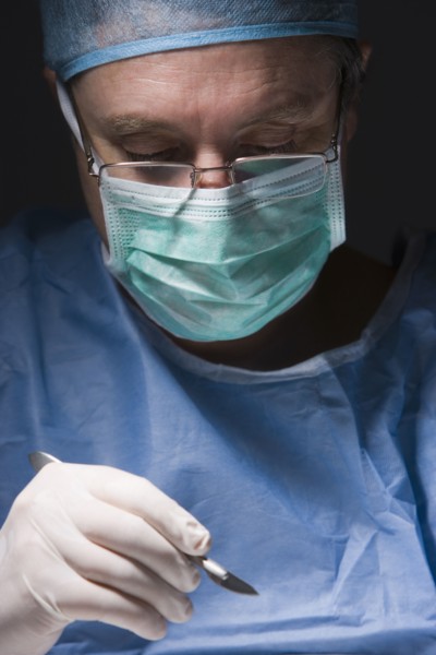 Caucasian surgeon performing surgery