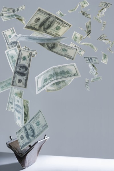 One hundred dollar bills floating out of purse