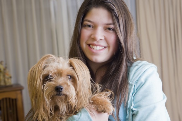 Hispanic girl holding dog
