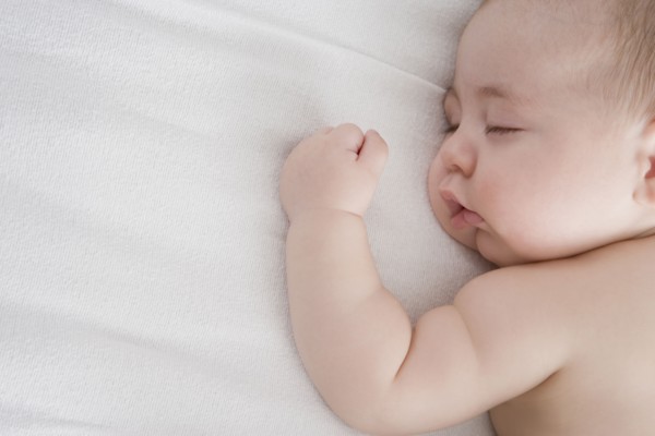 Hispanic baby boy sleeping on bed