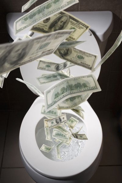 Dollar bills falling into toilet