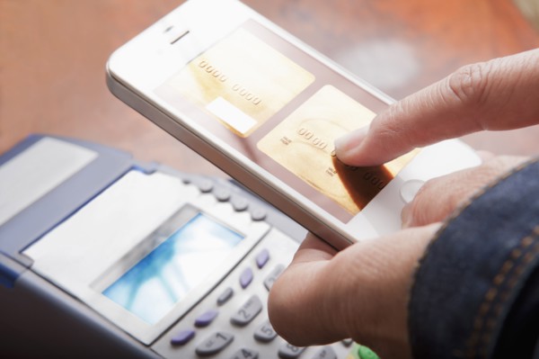 Hispanic woman paying with cell phone